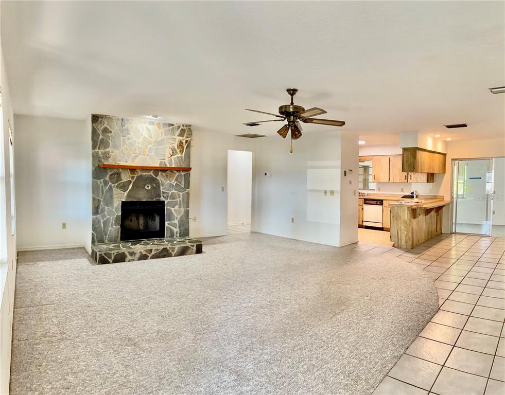 1638 Lamplighter Way Orlando, FL 32818 - Photo 3 of 25 a view of a livingroom with a fireplace and a chandelier