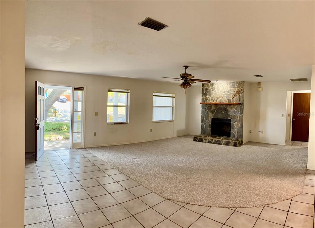 1638 Lamplighter Way Orlando, FL 32818 - Photo 5 of 25 an empty room with windows and fireplace