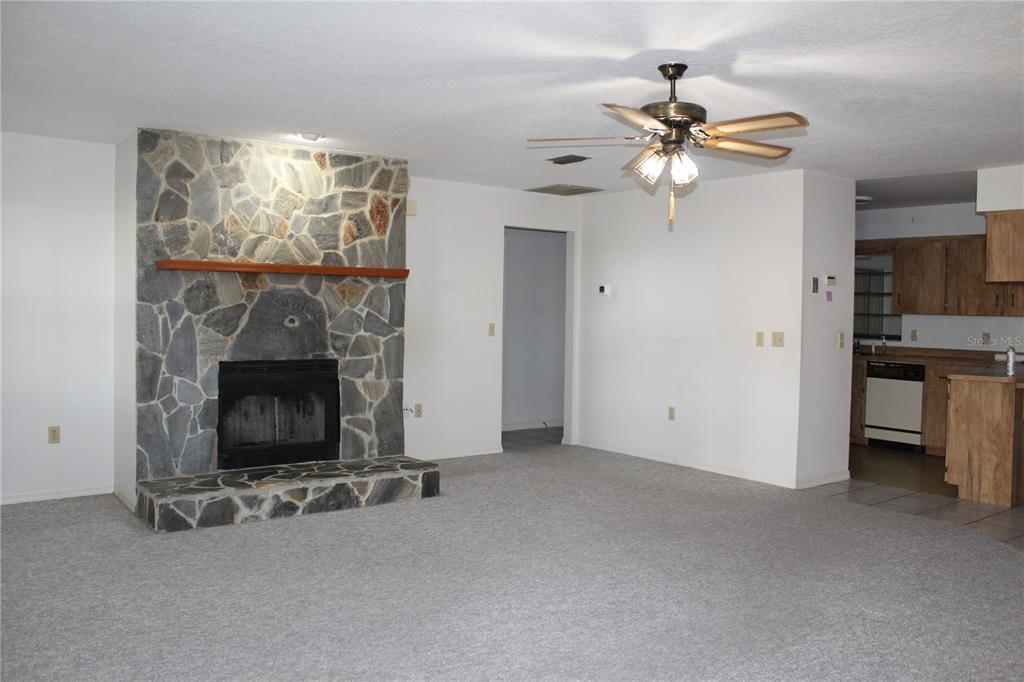 1638 Lamplighter Way Orlando, FL 32818 - Photo 6 of 25 a view of a livingroom with furniture and a fireplace