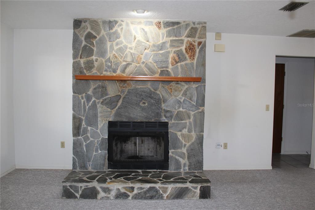 1638 Lamplighter Way Orlando, FL 32818 - Photo 7 of 25 a room with fireplace
