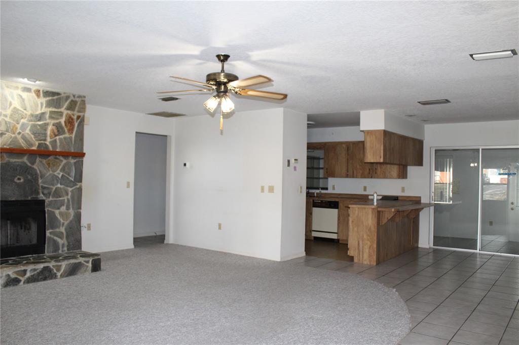 1638 Lamplighter Way Orlando, FL 32818 - Photo 9 of 25 a view of a kitchen with a sink a refrigerator and a fireplace