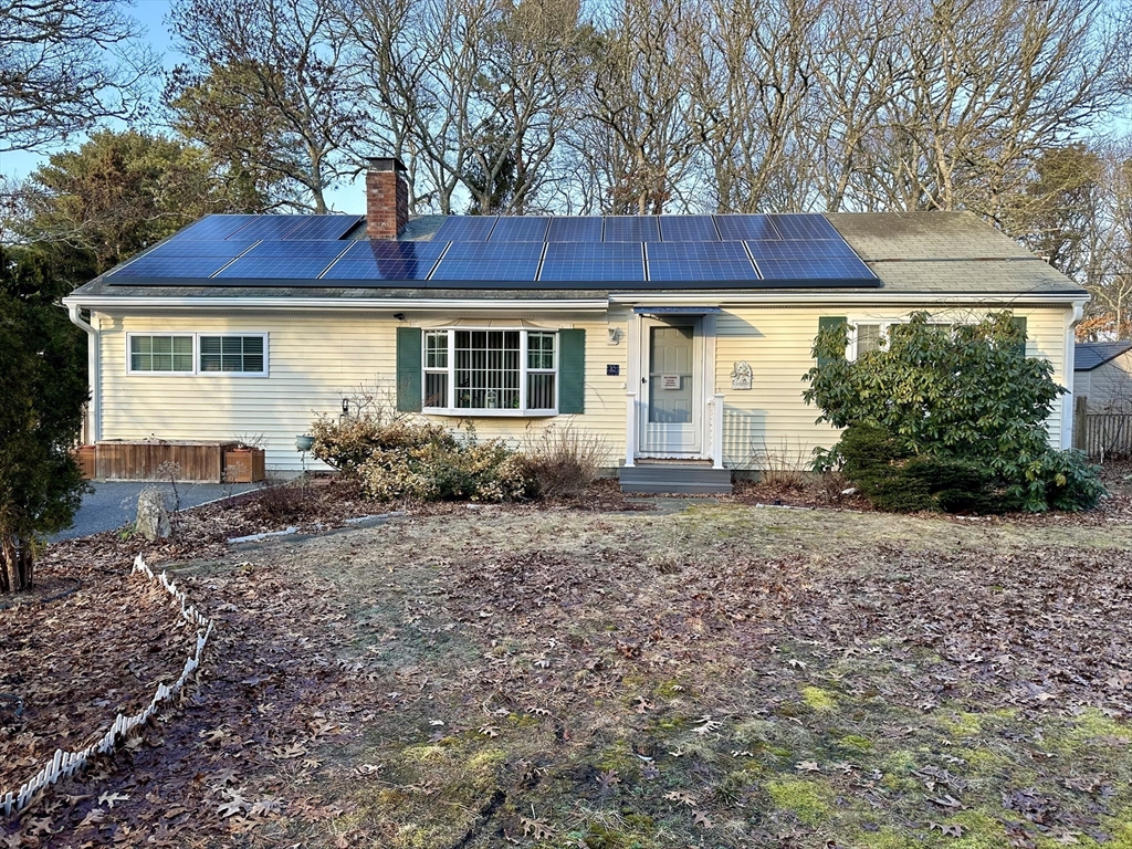 a view of a house with a yard and plants