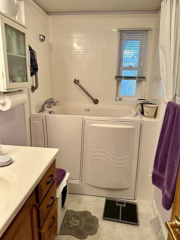 32 Shallow Brook Road Yarmouth, MA 02664 - Photo 13 of 18 a bathroom with a sink a mirror and shower