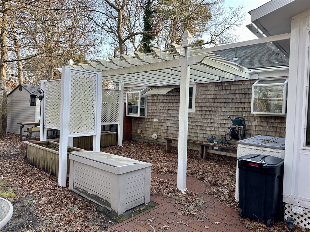 32 Shallow Brook Road Yarmouth, MA 02664 - Photo 16 of 18 a view of a patio with couches chairs and a fire pit