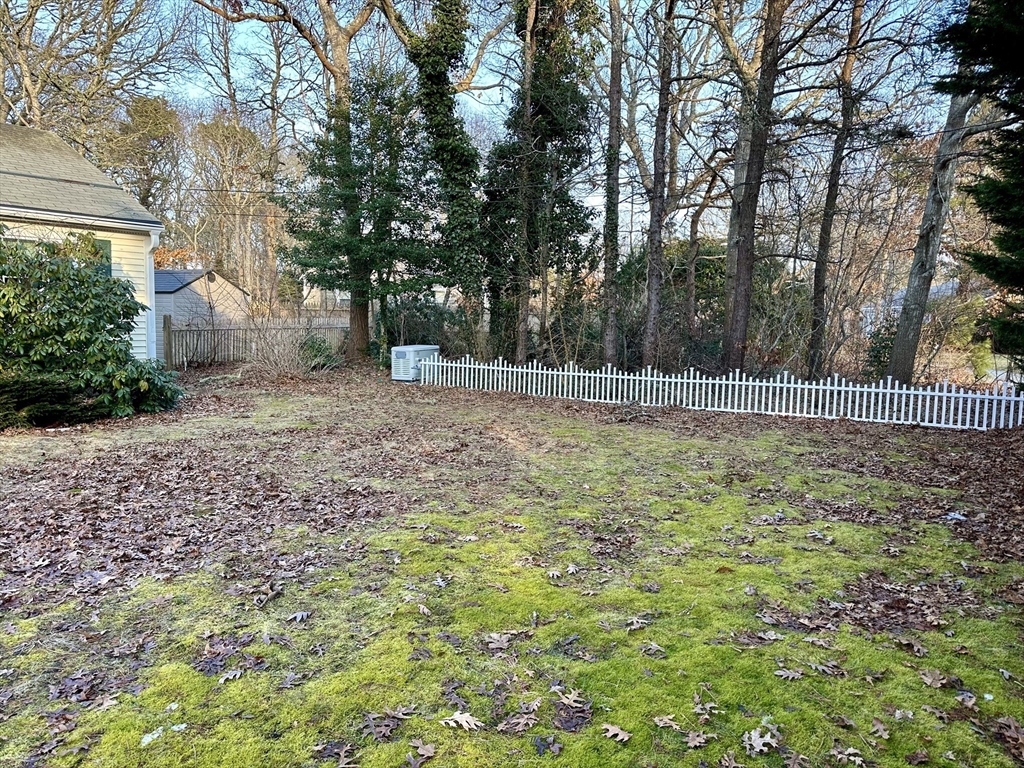 32 Shallow Brook Road Yarmouth, MA 02664 - Photo 18 of 18 a view of a backyard with large trees