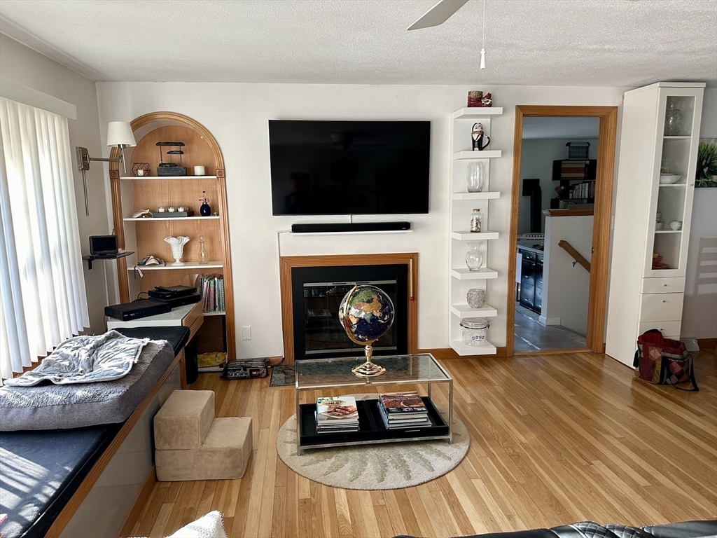 32 Shallow Brook Road Yarmouth, MA 02664 - Photo 4 of 18 a living room with furniture and a fireplace