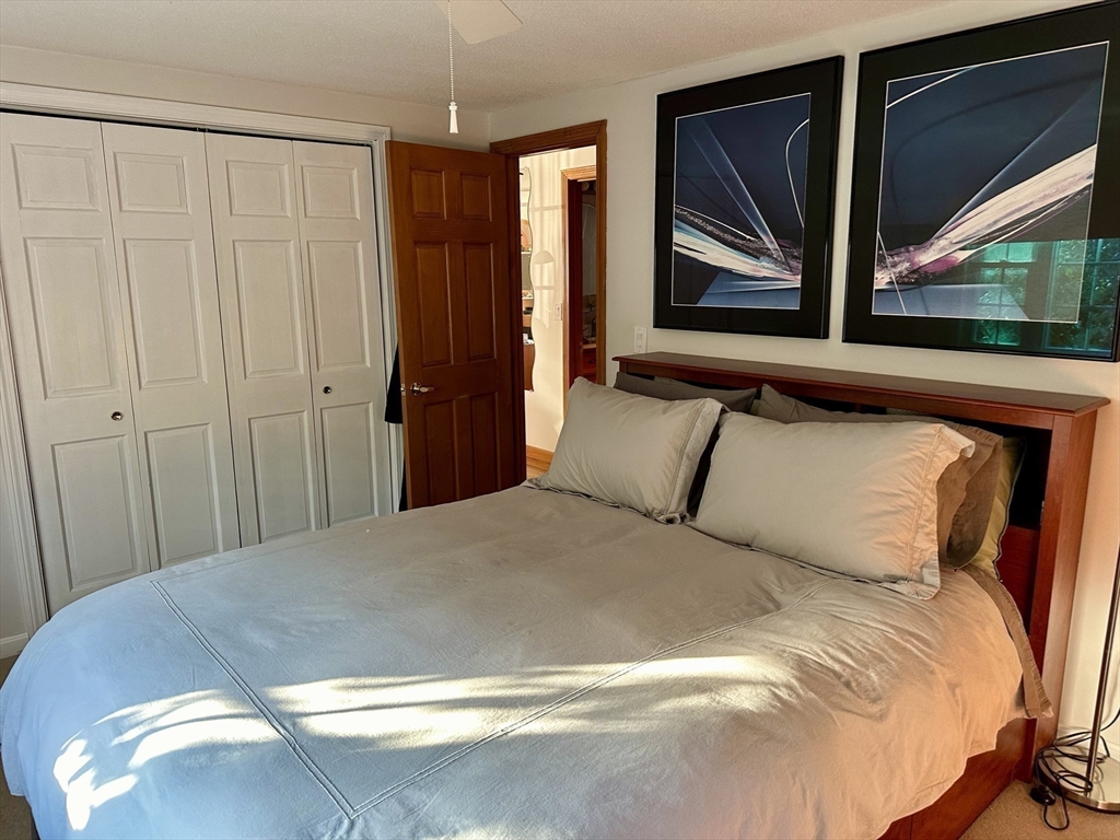 32 Shallow Brook Road Yarmouth, MA 02664 - Photo 7 of 18 a bedroom with a bed and a painting on the wall