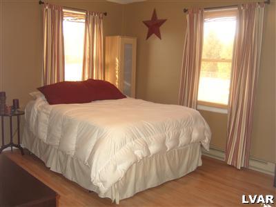 202 Ruth Road Bath, PA 18014 - Photo 7 of 10 a large bed sitting in a bedroom next to a window