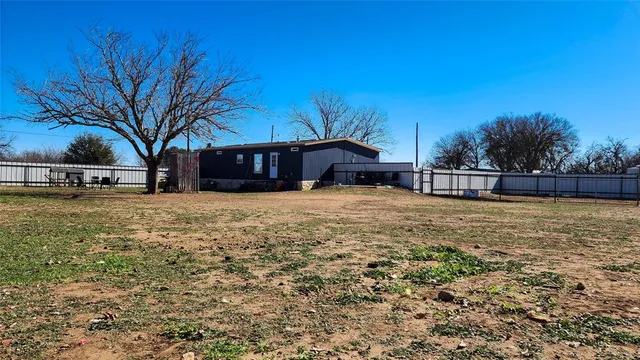 a view of a house with a yard covered with snow
