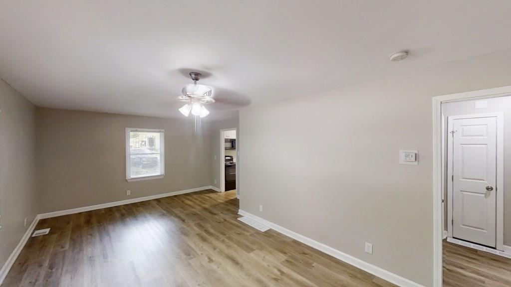 568 McWilliams Road Southeast Atlanta, GA 30315 - Photo 2 of 17 wooden floor in an empty room with a window