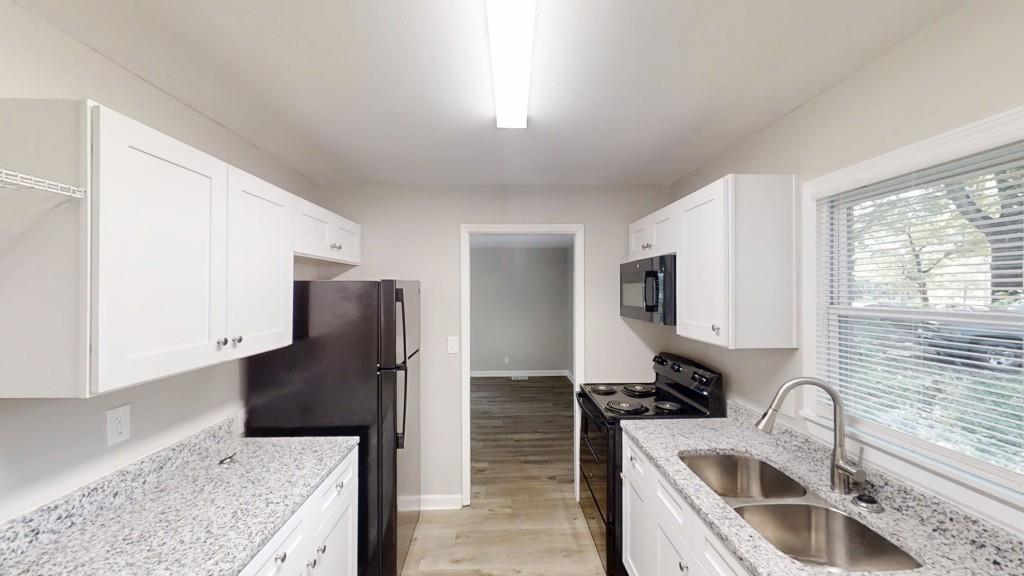 568 McWilliams Road Southeast Atlanta, GA 30315 - Photo 5 of 17 a kitchen with stainless steel appliances granite countertop a sink stove and refrigerator