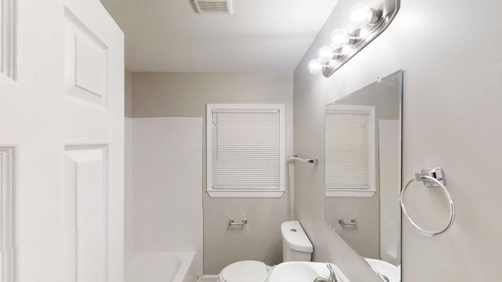 568 McWilliams Road Southeast Atlanta, GA 30315 - Photo 10 of 17 a bathroom with a toilet and a shower