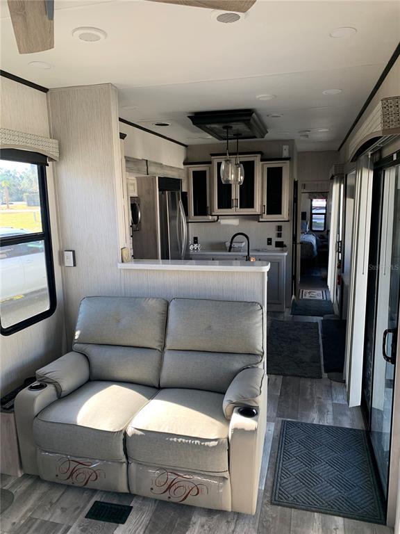 15991 Northeast 243rd Place Road, Unit 143 Fort McCoy, FL 32134 - Photo 12 of 35 a living room with furniture and a flat screen tv