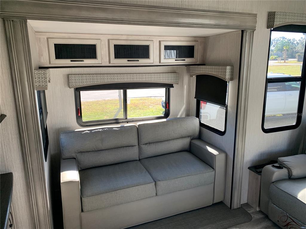 15991 Northeast 243rd Place Road, Unit 143 Fort McCoy, FL 32134 - Photo 13 of 35 a living room with furniture and a fireplace