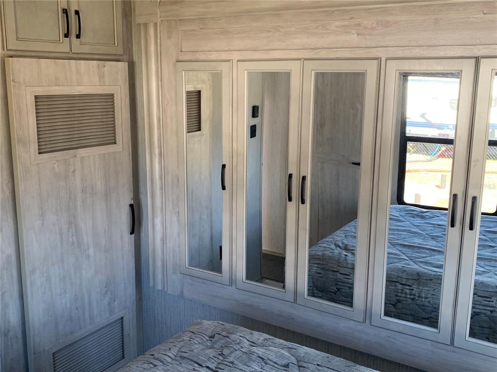 15991 Northeast 243rd Place Road, Unit 143 Fort McCoy, FL 32134 - Photo 18 of 35 a view of a hallway with wooden floor and a livingroom