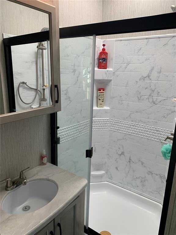 15991 Northeast 243rd Place Road, Unit 143 Fort McCoy, FL 32134 - Photo 19 of 35 a bathroom with a sink and a shower