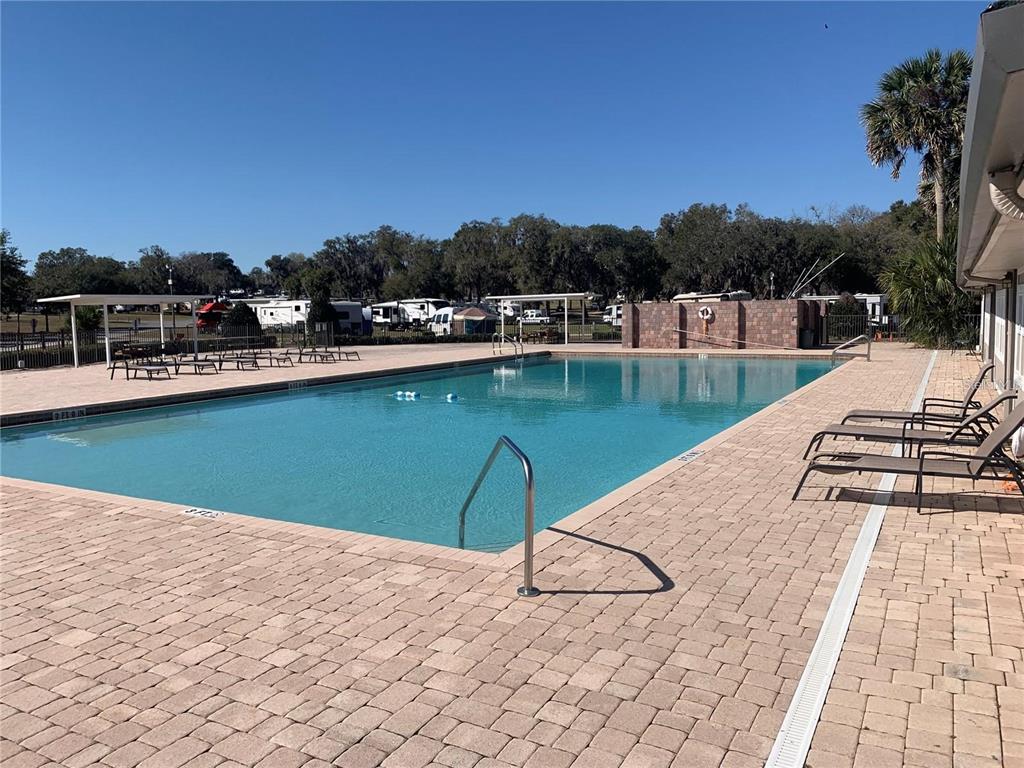 15991 Northeast 243rd Place Road, Unit 143 Fort McCoy, FL 32134 - Photo 23 of 35 a view of a lake with chairs
