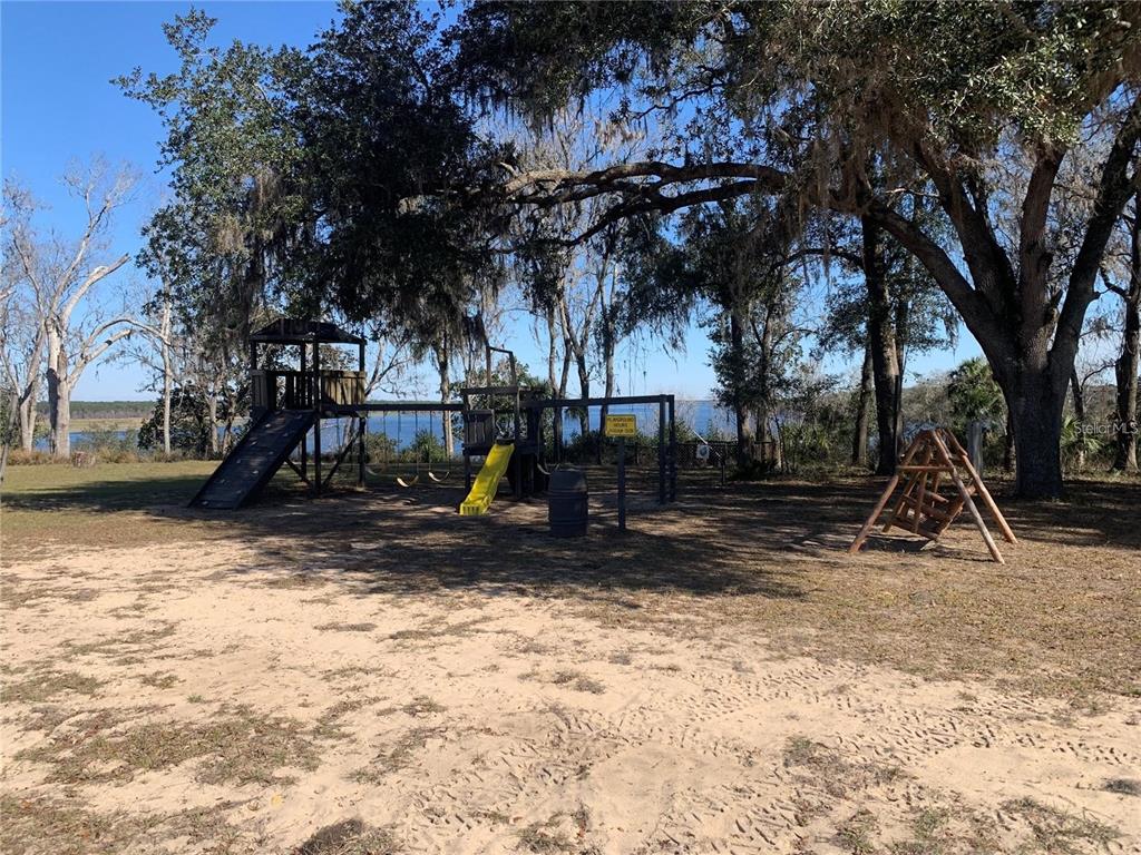 15991 Northeast 243rd Place Road, Unit 143 Fort McCoy, FL 32134 - Photo 30 of 35 a view of outdoor space with playground and green space