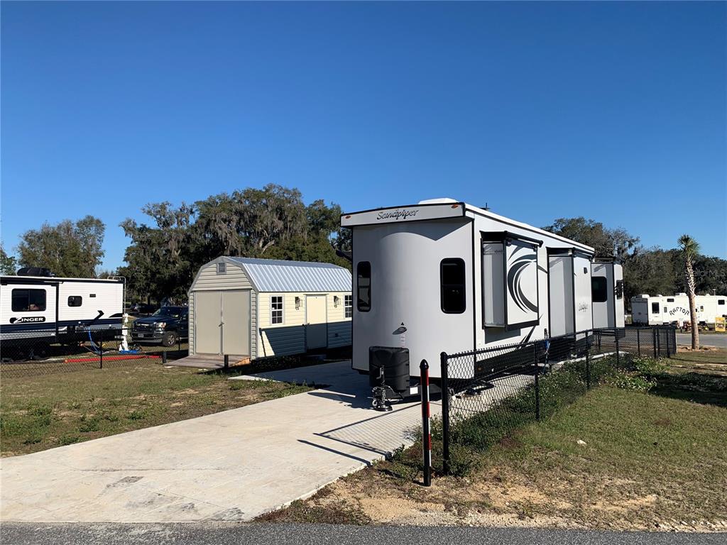 15991 Northeast 243rd Place Road, Unit 143 Fort McCoy, FL 32134 - Photo 4 of 35 a front view of a house with garden