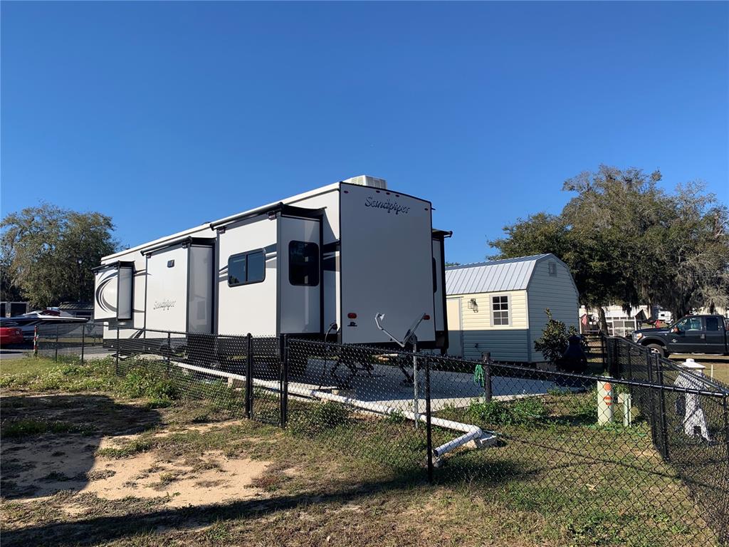 15991 Northeast 243rd Place Road, Unit 143 Fort McCoy, FL 32134 - Photo 6 of 35 a front view of a house with garden