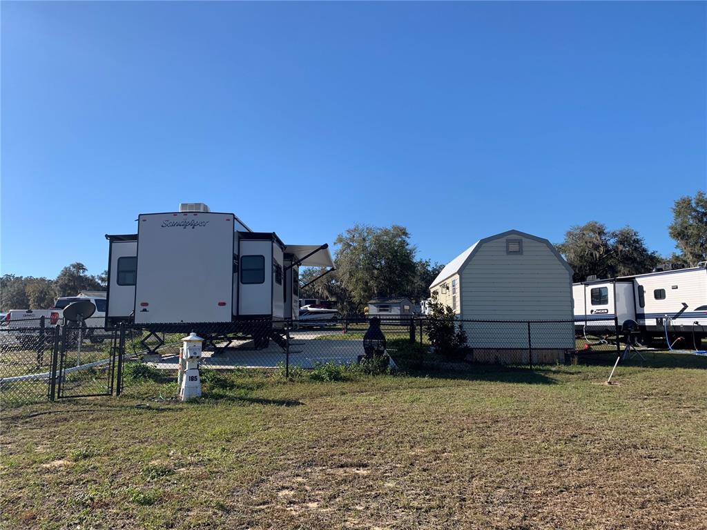 15991 Northeast 243rd Place Road, Unit 143 Fort McCoy, FL 32134 - Photo 7 of 35 a backyard of a house with barbeque oven
