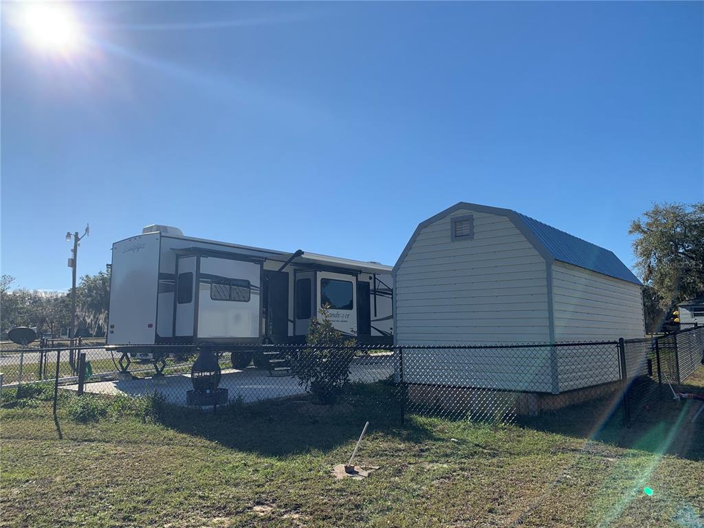 15991 Northeast 243rd Place Road, Unit 143 Fort McCoy, FL 32134 - Photo 8 of 35 a view of a house with a yard
