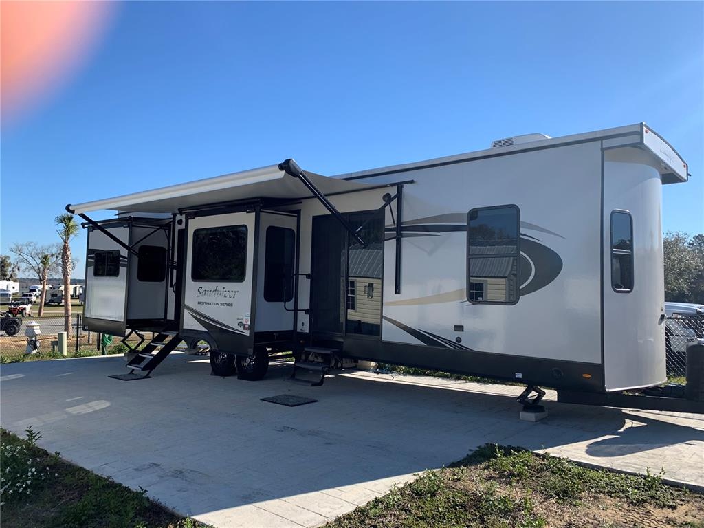 15991 Northeast 243rd Place Road, Unit 143 Fort McCoy, FL 32134 - Photo 9 of 35 a car parked in front of a house