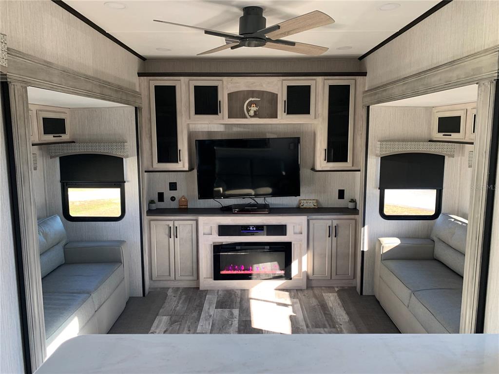 15991 Northeast 243rd Place Road, Unit 143 Fort McCoy, FL 32134 - Photo 10 of 35 a living room with furniture and a fireplace