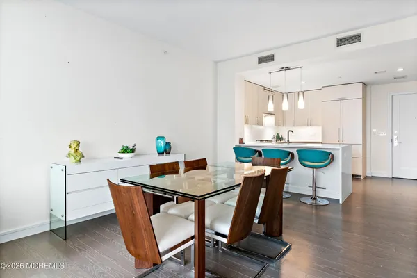 a dining room with furniture and wooden floor