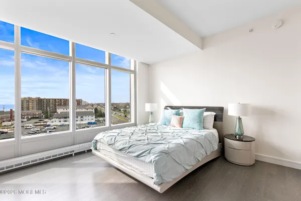 a large bed sitting in a room next to a lamp