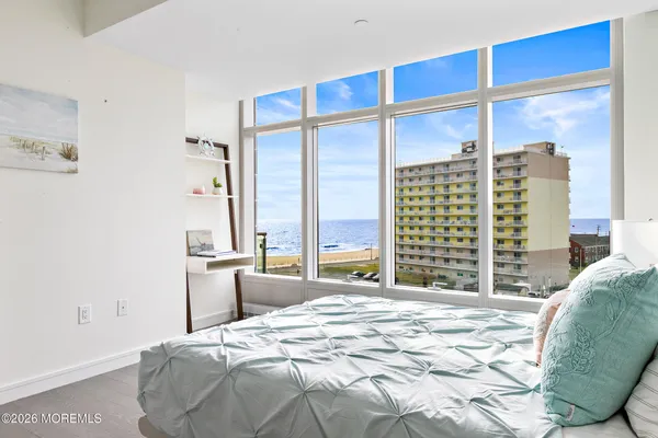 a bedroom with a large bed and a large window