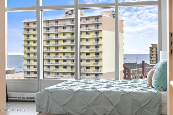 a bedroom with a bed and a large window