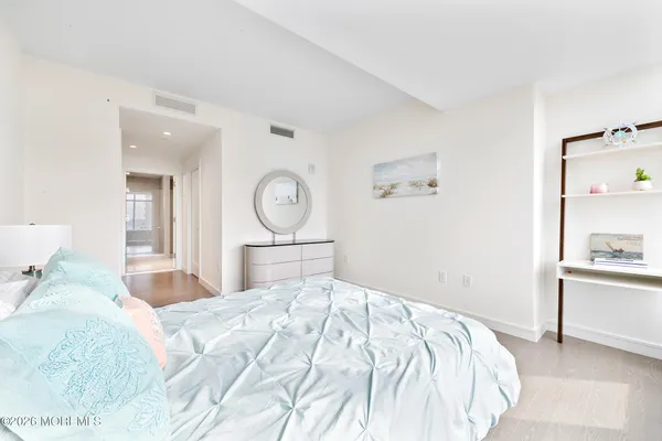 a bedroom with a bed and a chandelier