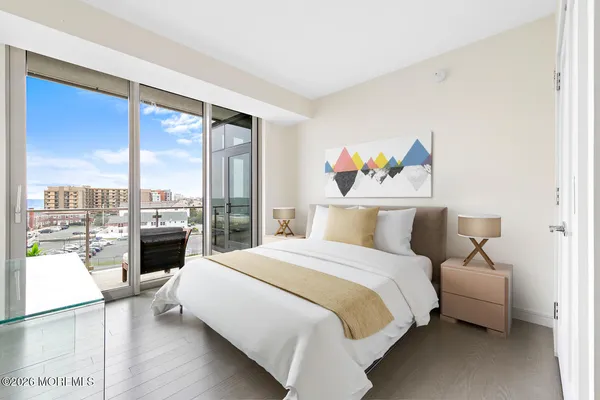 a spacious bedroom with a bed and a large window