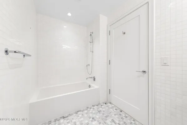 a bathroom with a bathtub and shower