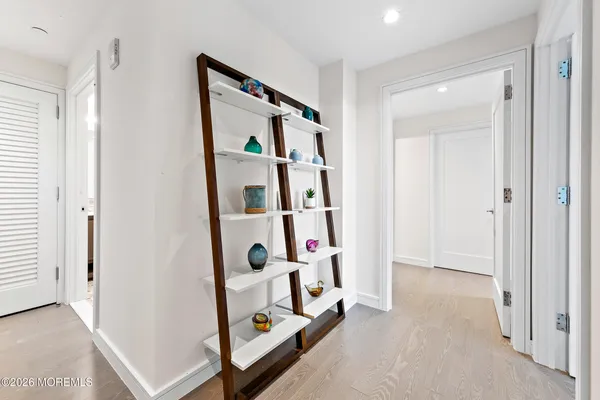 a vase of flowers sitting on a table near a hallway