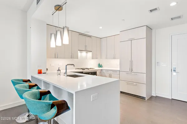 a kitchen with a white cabinets and white appliances
