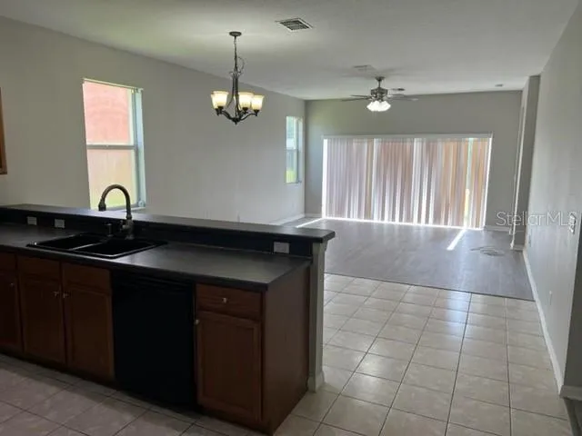 a kitchen with a sink and chandelier