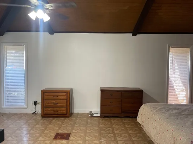 a bedroom with a bed and a dresser