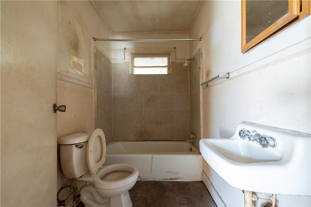 106 Frances Street Anderson, SC 29621 - Photo 14 of 15 Primary bathroom features a bathtub, toilet, and sink, ready for a refresh.