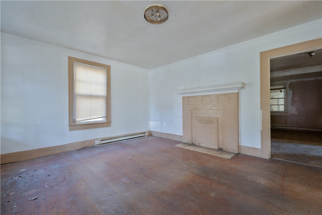 106 Frances Street Anderson, SC 29621 - Photo 4 of 15 This interior offers a classic fireplace and hardwood flooring, ready for your personal touch.