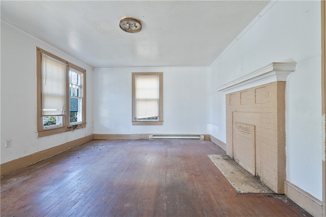 106 Frances Street Anderson, SC 29621 - Photo 5 of 15 This inviting living area features warm wood flooring and a classic fireplace.