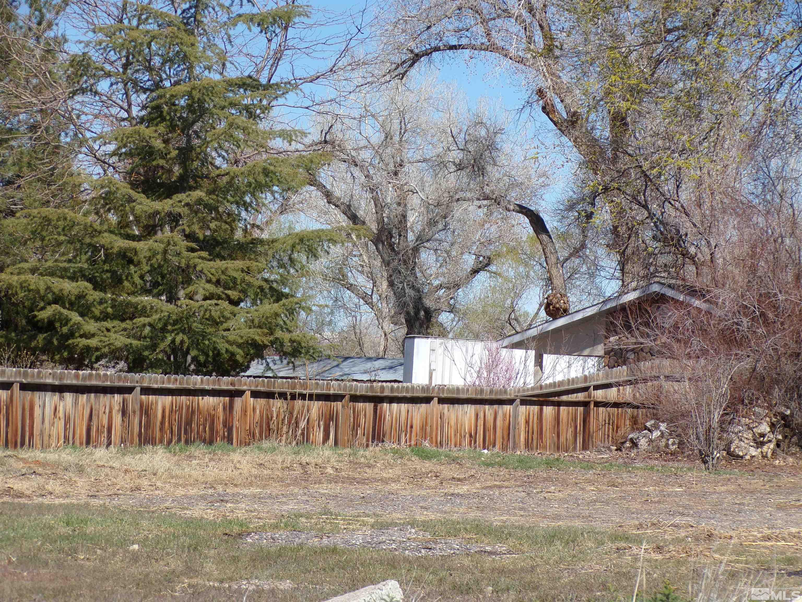 5890 Rivers Edge Drive Fallon, NV 89406 - Photo 20 of 24 a view of backyard with wooden fence