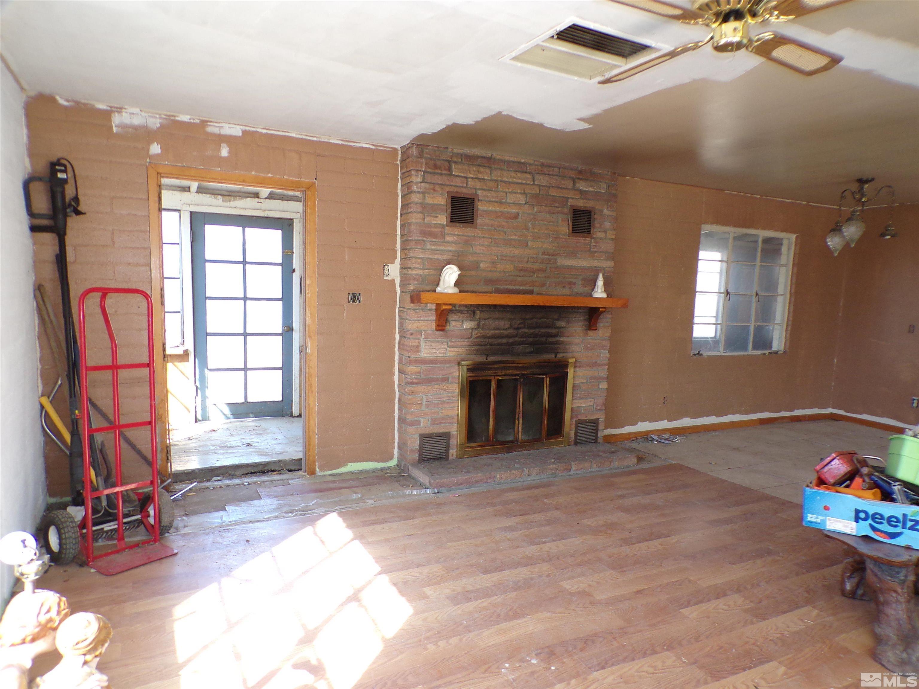 5890 Rivers Edge Drive Fallon, NV 89406 - Photo 24 of 24 a view of an empty room with a fireplace and toys
