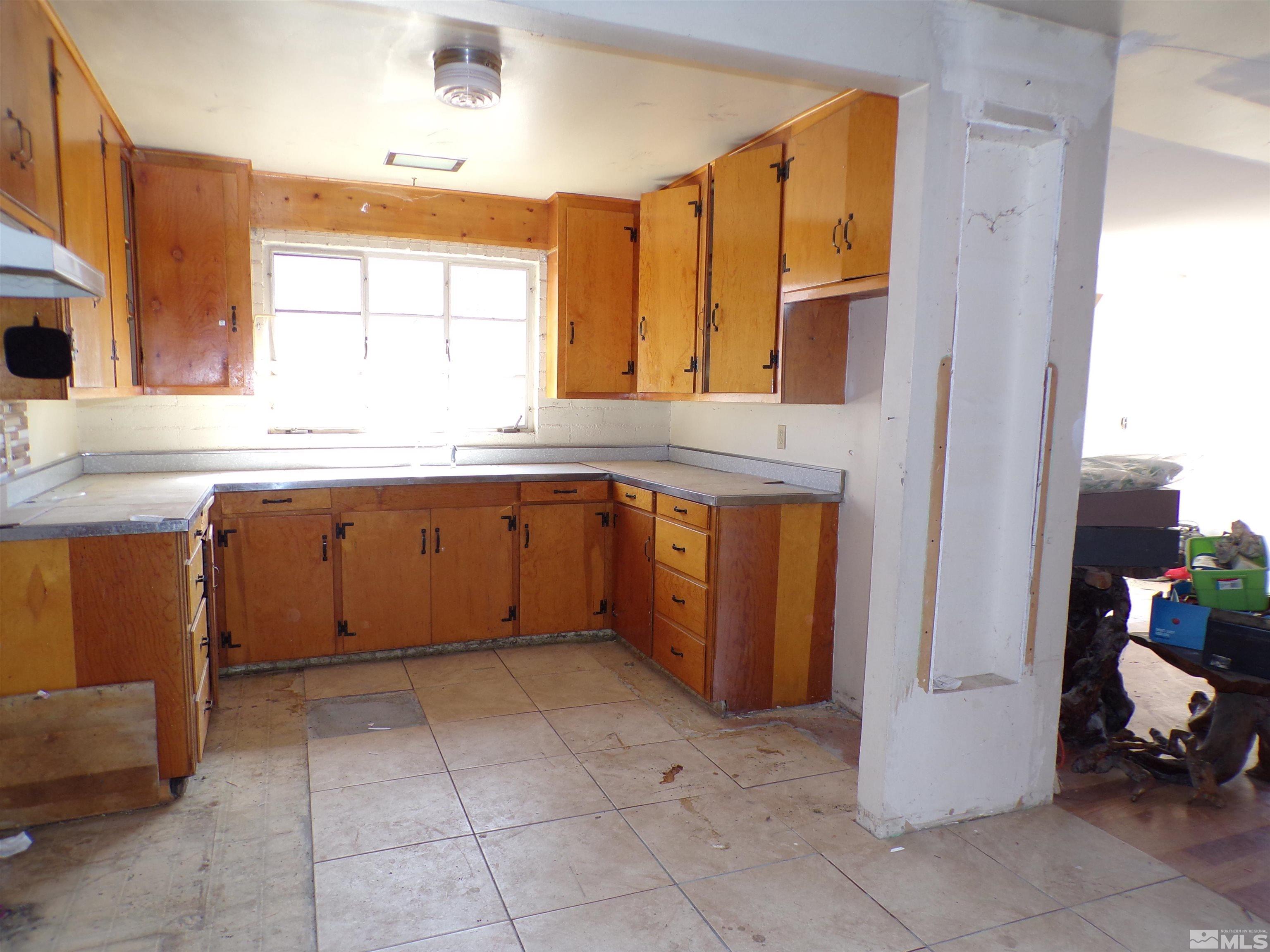 5890 Rivers Edge Drive Fallon, NV 89406 - Photo 3 of 24 a kitchen with a sink and a refrigerator