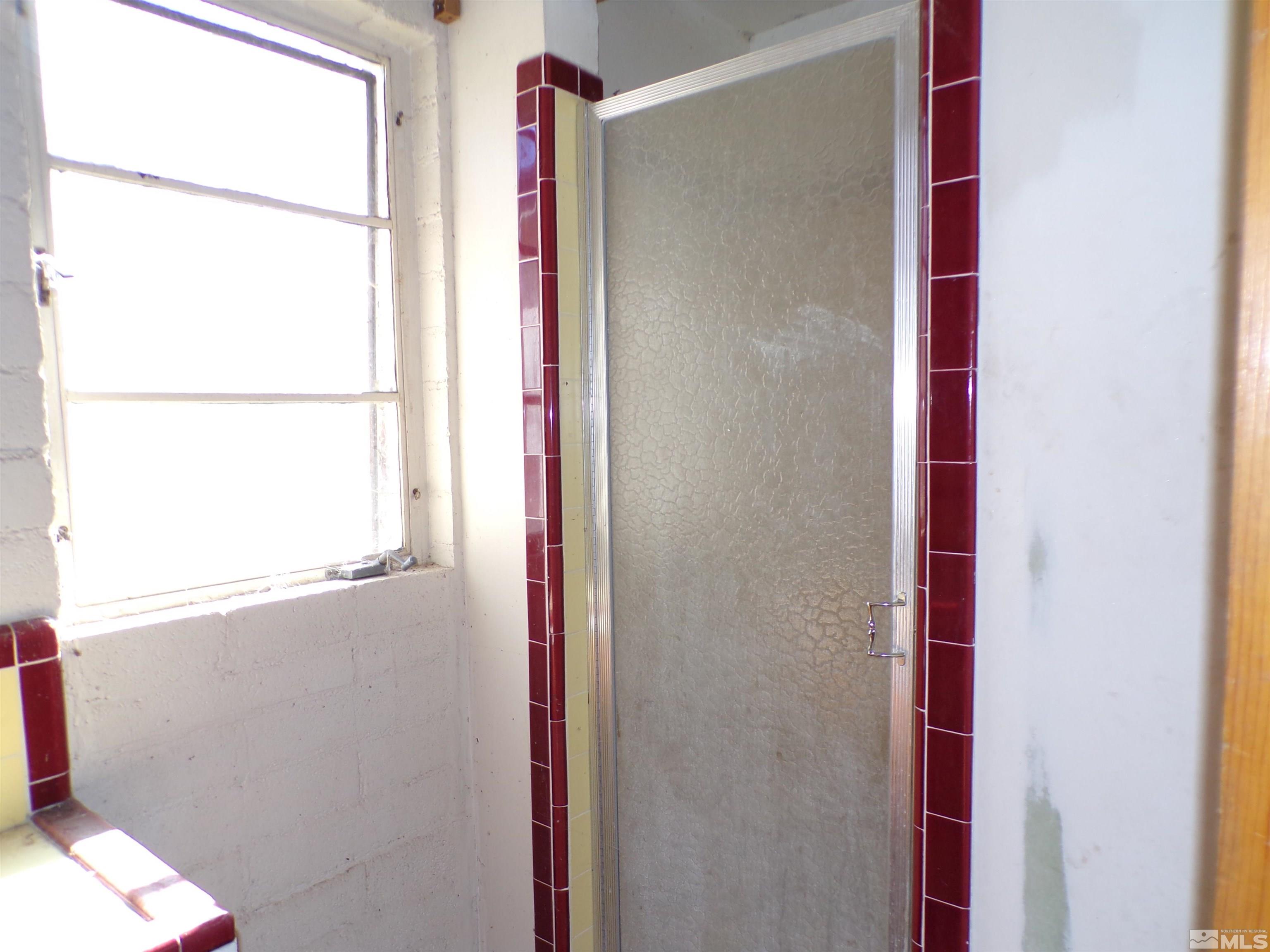 5890 Rivers Edge Drive Fallon, NV 89406 - Photo 6 of 24 a bathroom with a window and a shower