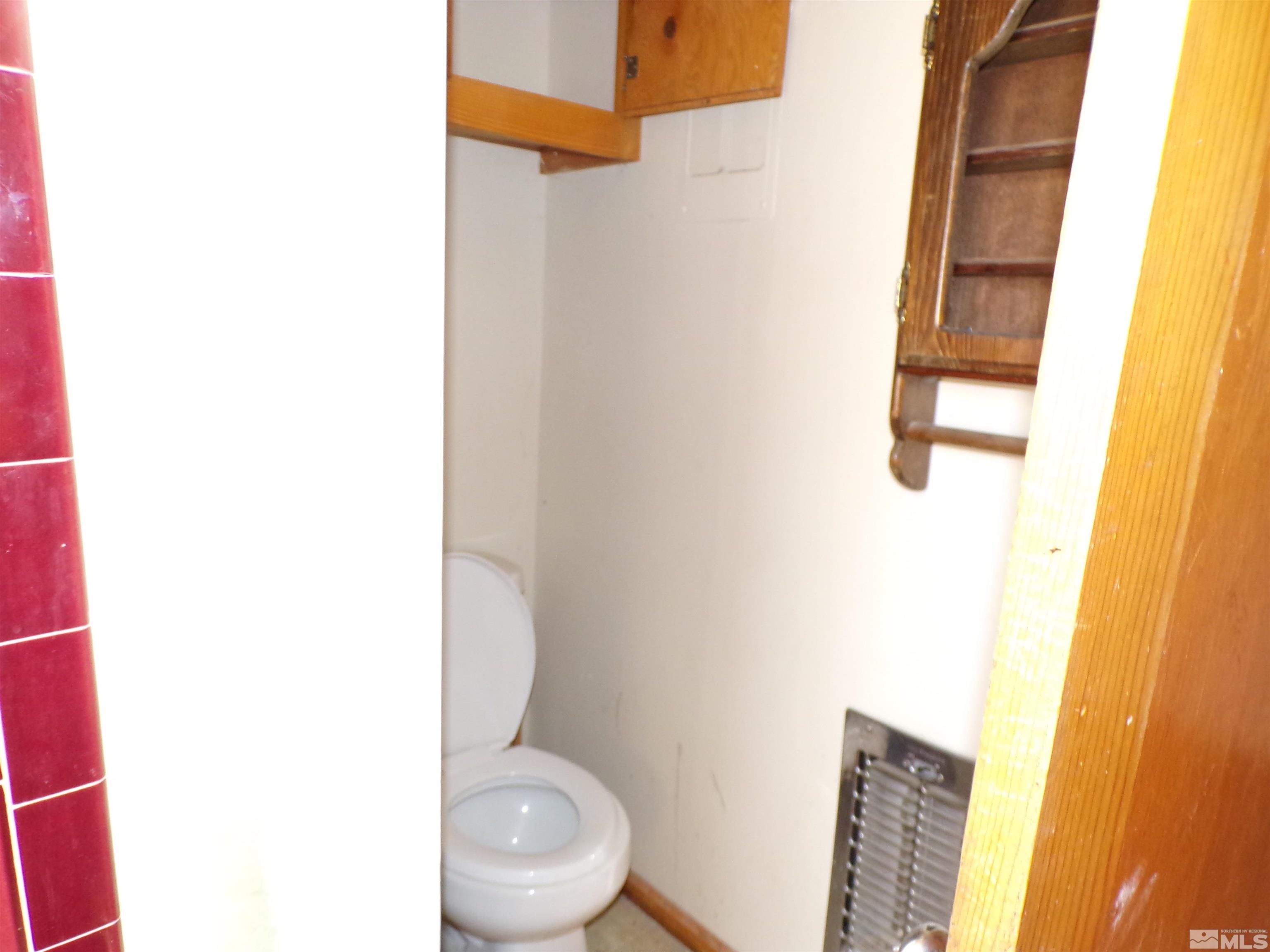 5890 Rivers Edge Drive Fallon, NV 89406 - Photo 7 of 24 a white toilet sitting next to a blue sink