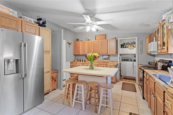 a kitchen with stainless steel appliances a refrigerator sink and stove