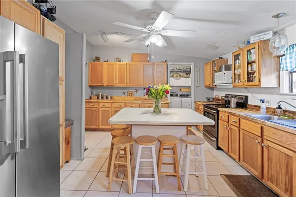 a kitchen with a refrigerator a sink and cabinets