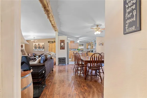 a dining room with furniture and wooden floor